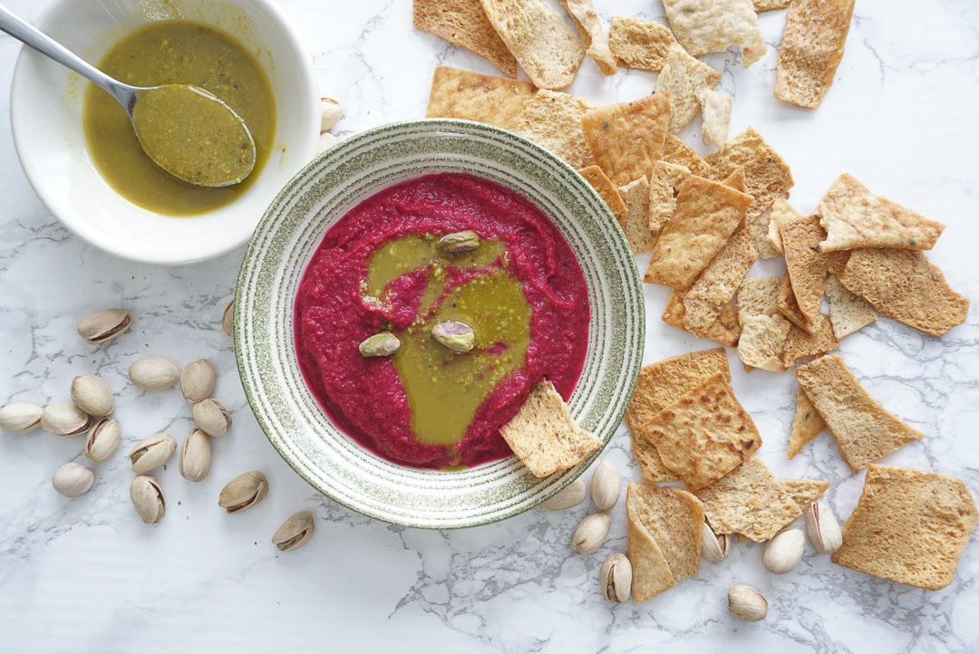 beautiful beet hummus with pistachios and pita chips