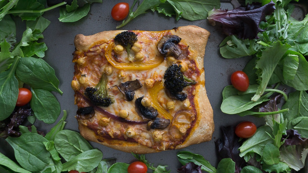 vegetable pizza with vegan cheese and homemade crust