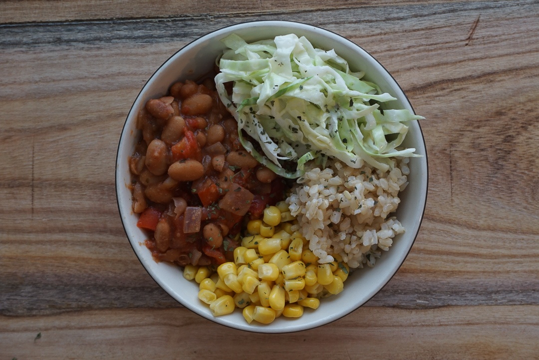 vegan chili bowl with rice corn and coleslaw