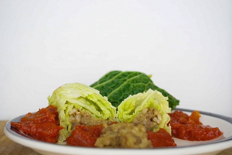 lentil and rice stuffed cabbage with cumin and tomato sauce