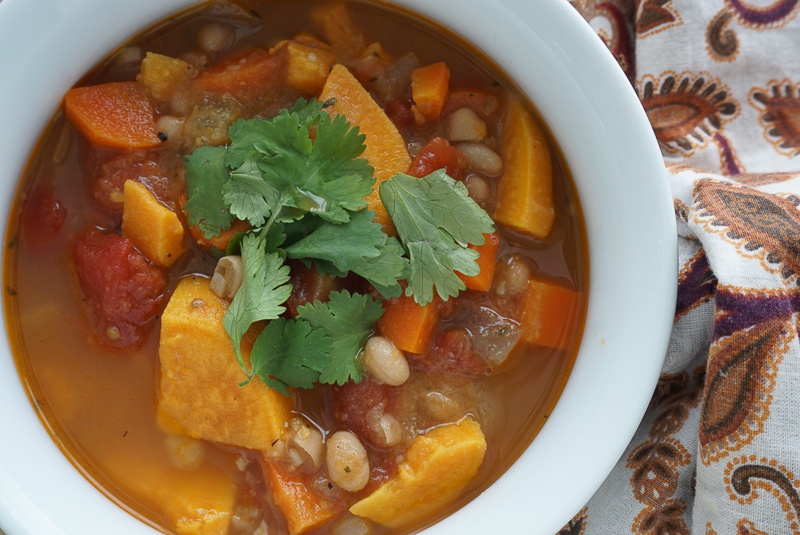 hearty winter vegan stew with navy beans and sweet potatoes